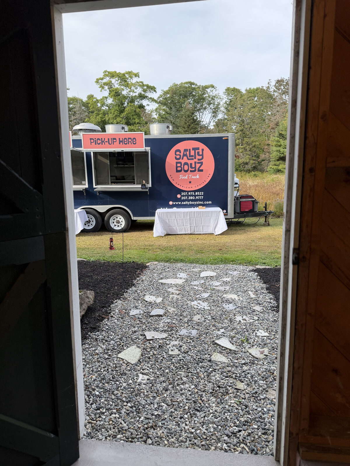 The view out the barn door: a food truck parked on the lawn, ready to serve guests