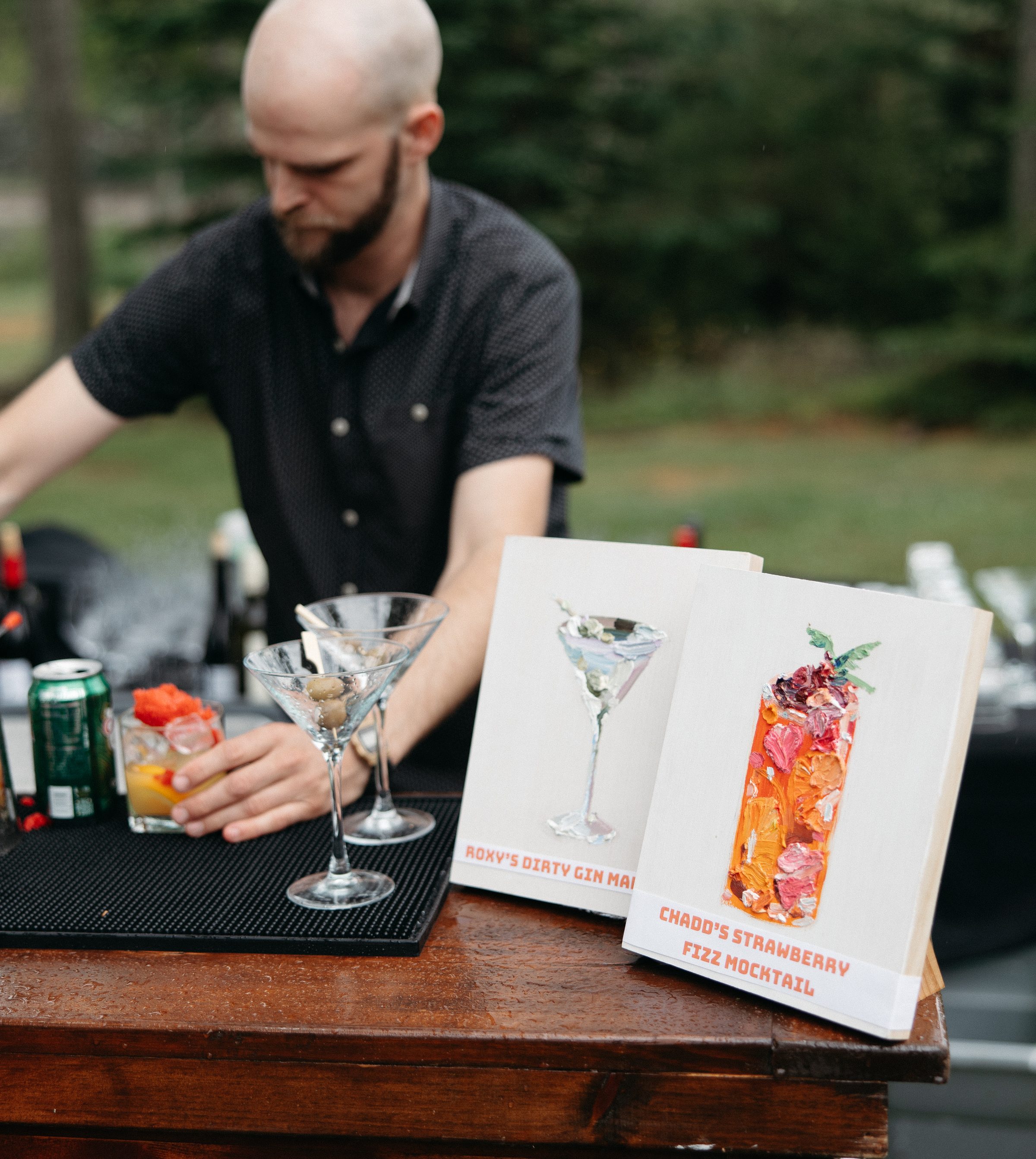 A bartender's station set up with a handwritten cocktail menu