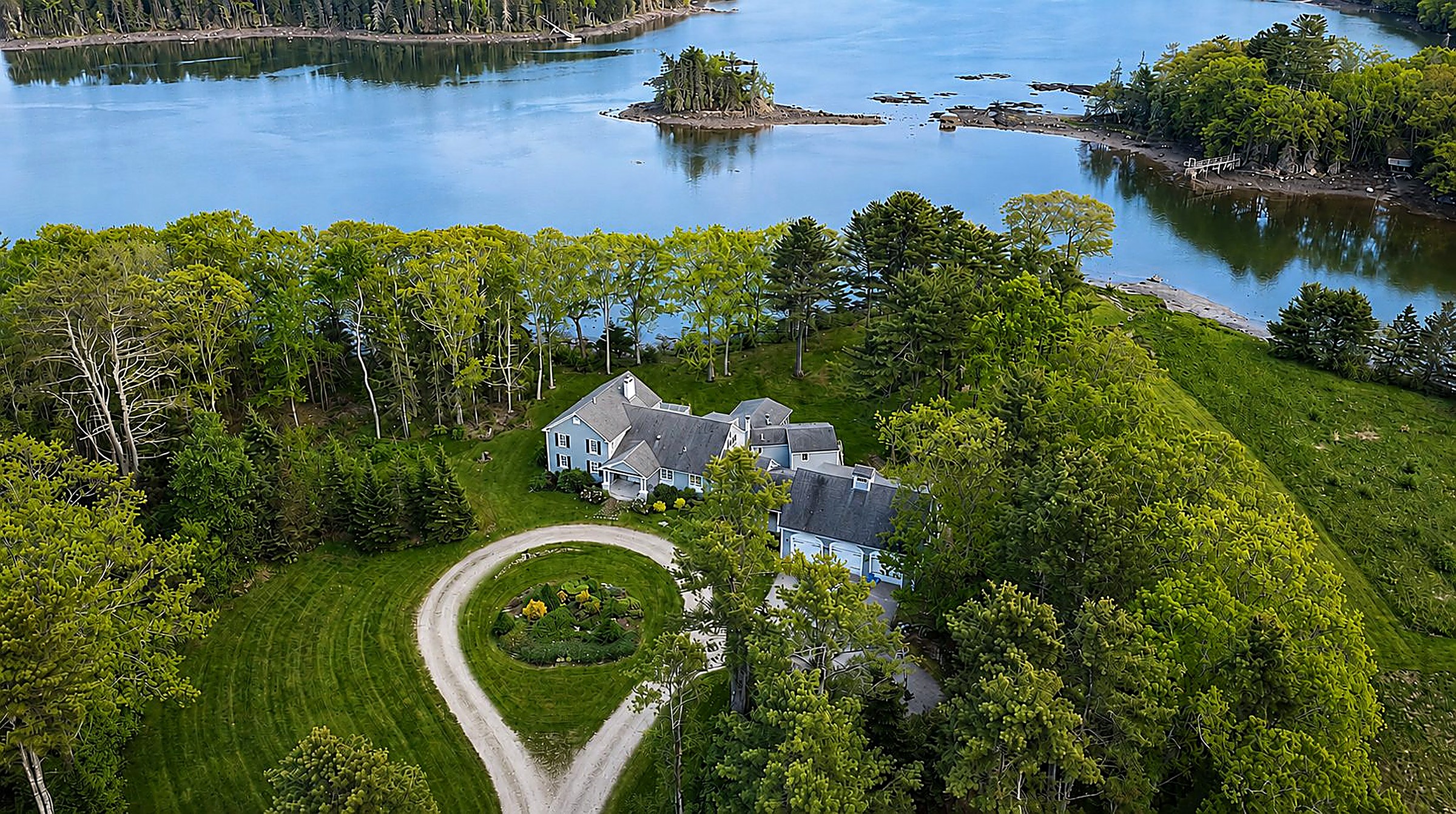 Aerial view of the estate house and grounds surrounded by trees on Pemaquid Harbor