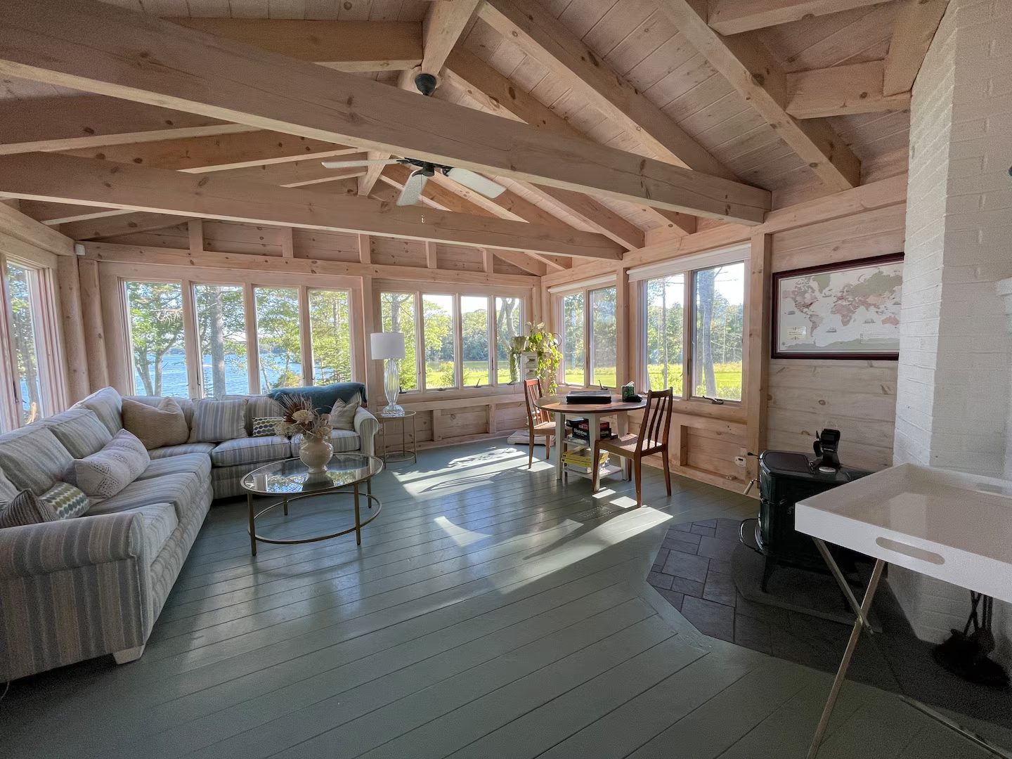 A sunroom with floor-to-ceiling windows looking straight out over the harbor