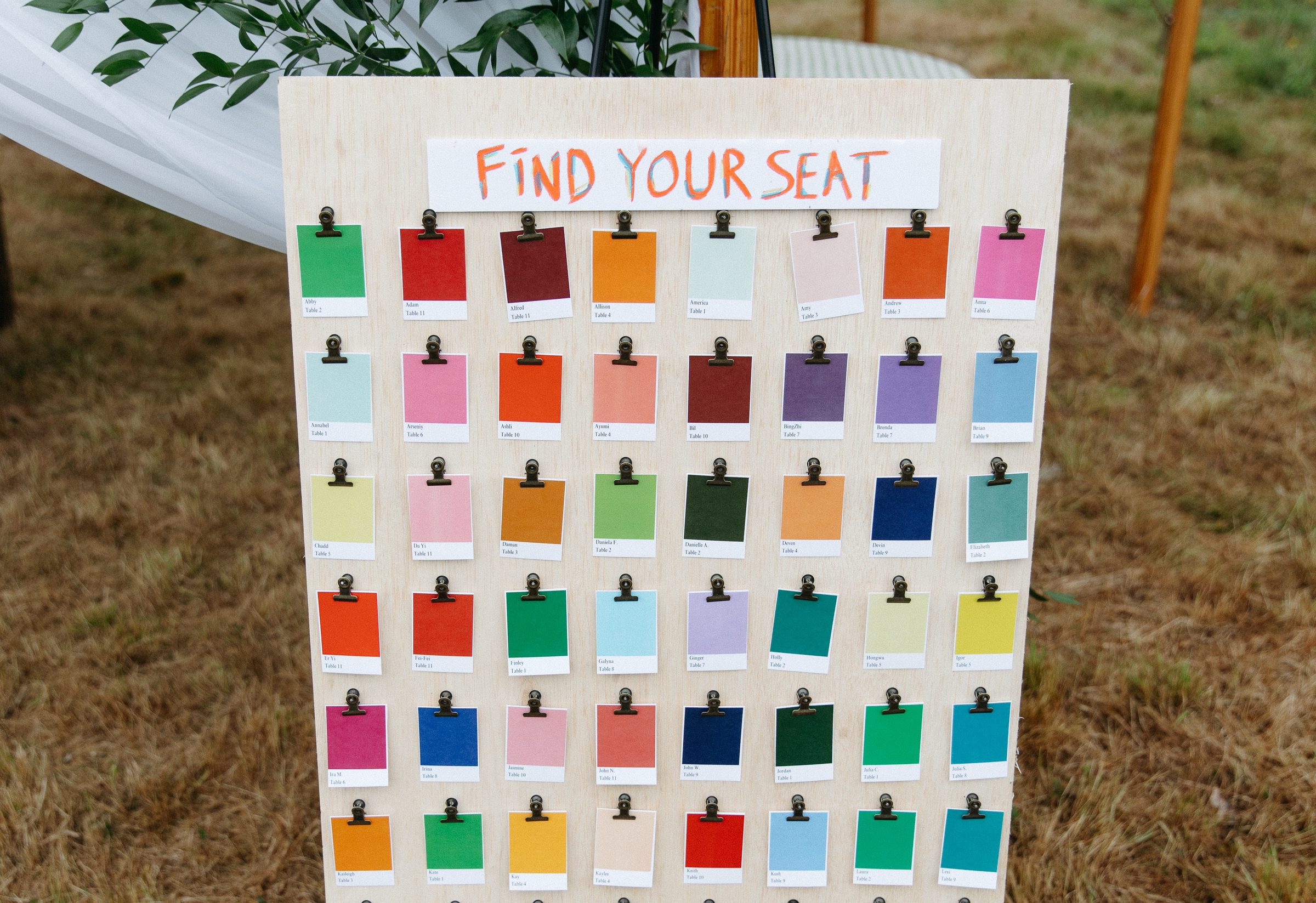 A colorful paint-swatch seating chart reading Find Your Seat